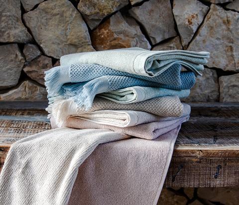 Stack of neatly folded Clarysse bath towels